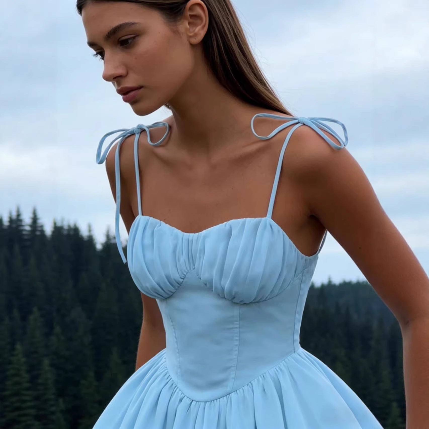 Woman wearing the Modarine tie-strap ruched-bodice mini dress