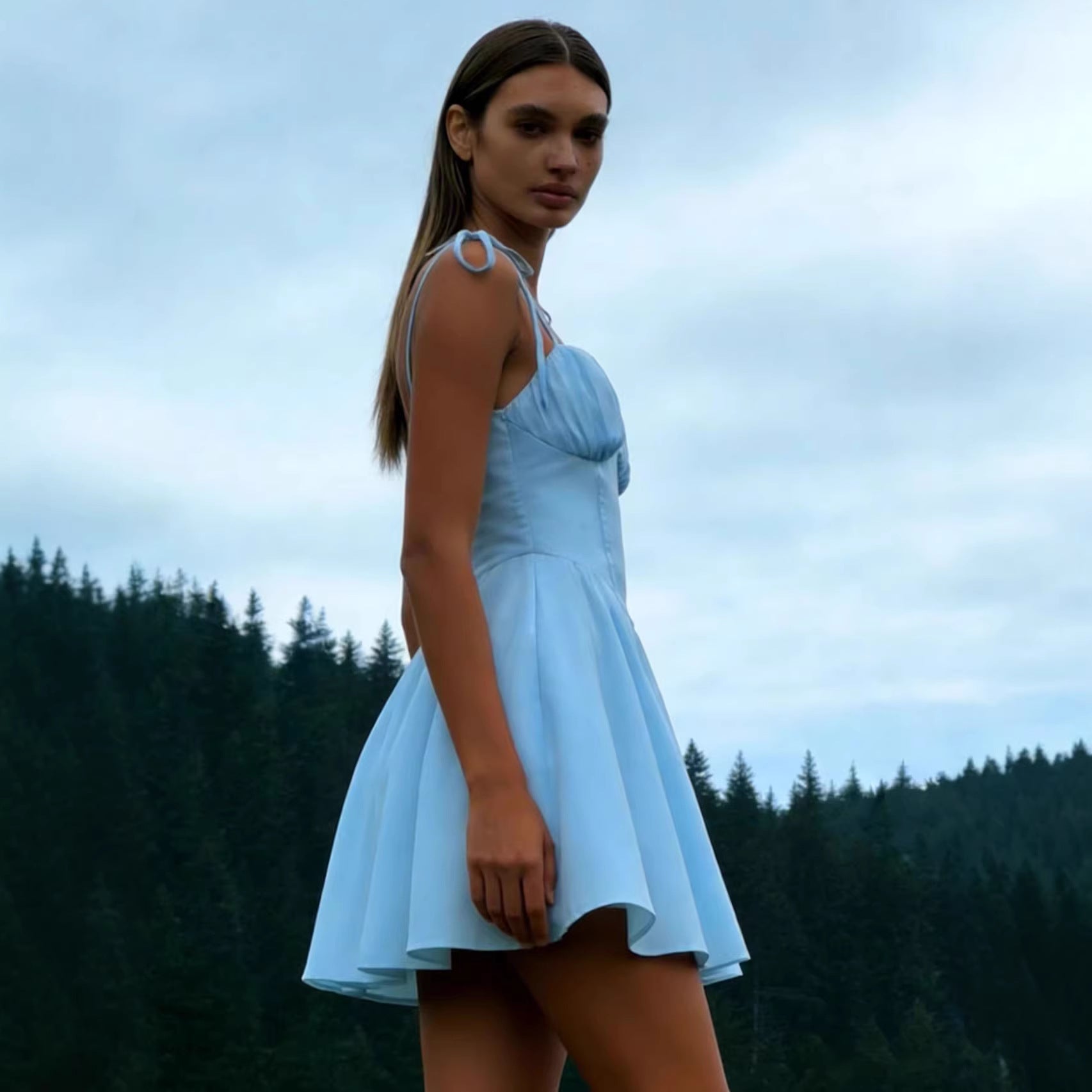 Woman wearing the Modarine tie-strap ruched-bodice mini dress